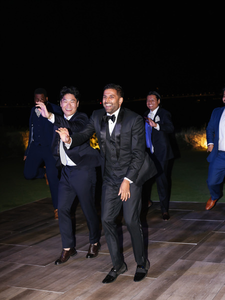 Groomsmen dancing together at Island Resort the Residence Indian wedding reception