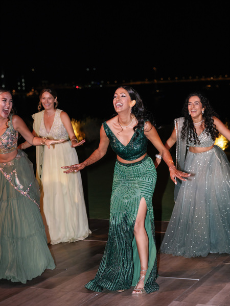 Bride dancing joyfully during nighttime reception at Island Resort the Residence Athens
