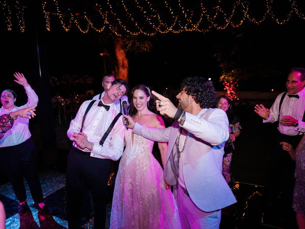 Late-night party singing at Villa Corsini Tuscany with disco balls and string lights.