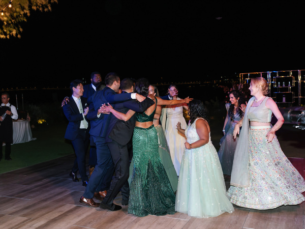 Bride dancing joyfully during nighttime reception at Island Resort the Residence Athens