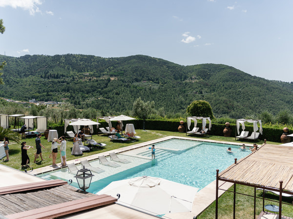 Guests swimming during Tuscany post-wedding pool party
