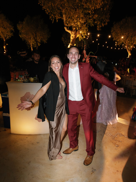 Guests celebrating near illuminated bar at Island Resort the Residence