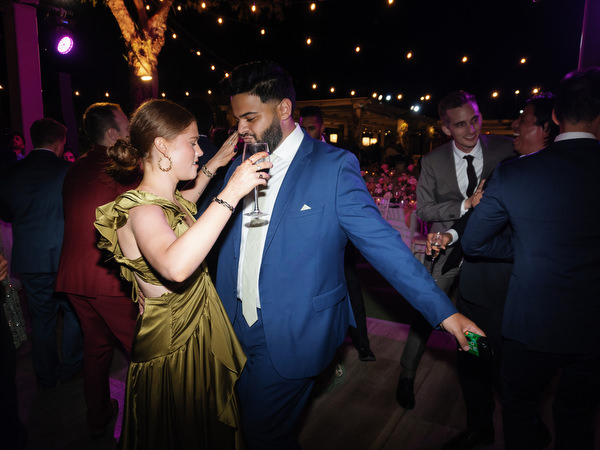 Guests dancing beside reception tables at Island Resort the Residence