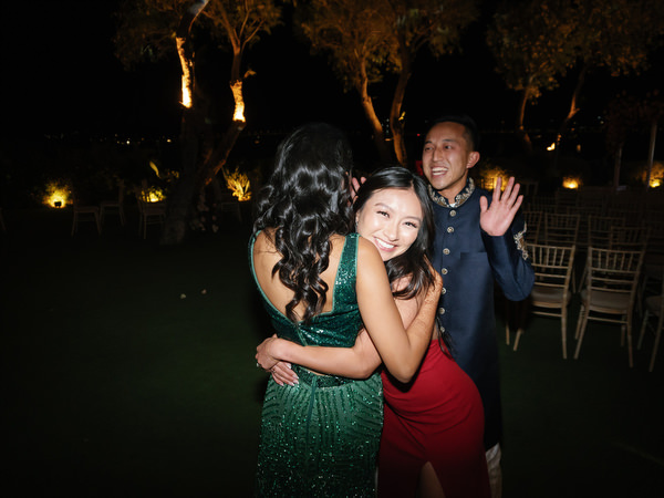 Guests hugging on the lawn at Island Resort the Residence nighttime reception