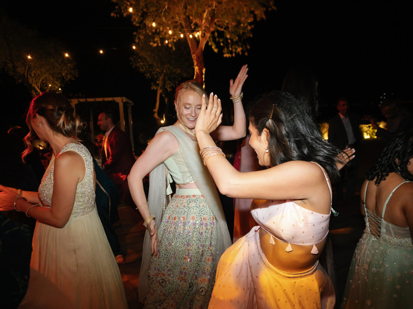 Guests hugging on the lawn at Island Resort the Residence nighttime reception