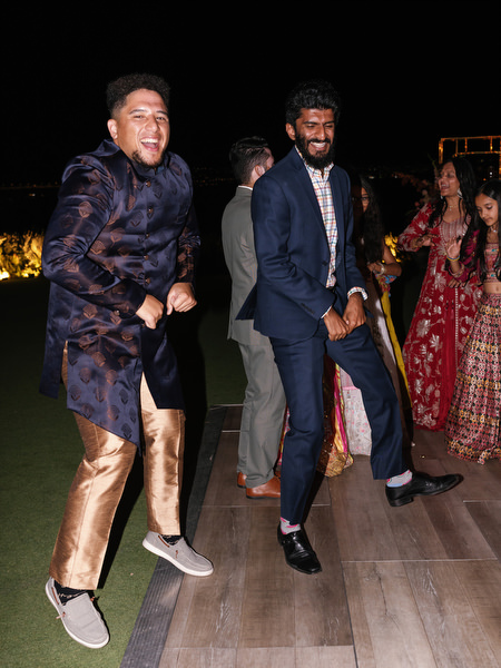 Groomsmen dancing on wooden dance floor at Island Resort the Residence
