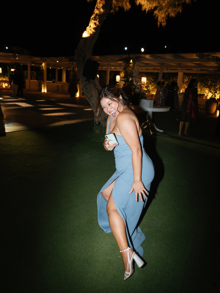 Guest dancing playfully on reception lawn at Island Resort the Residence