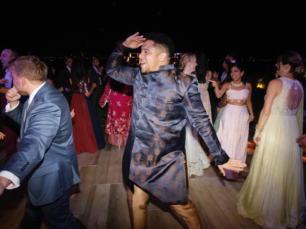 Energetic dance floor moment during Indian wedding in Athens at Island Resort