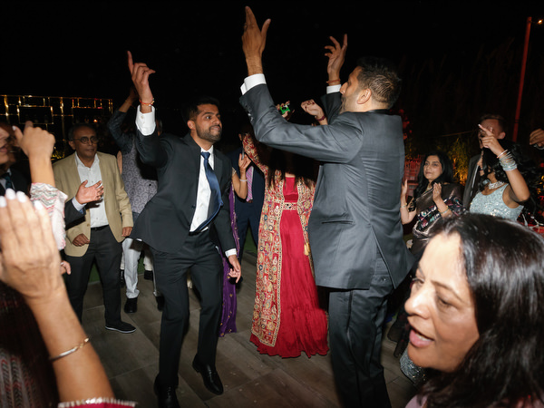 Guest leading dance circle at Island Resort the Residence reception