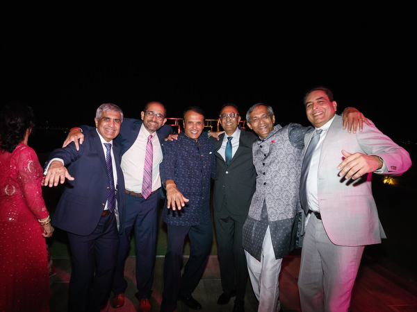 Friends posing together during night celebration at Island Resort the Residence