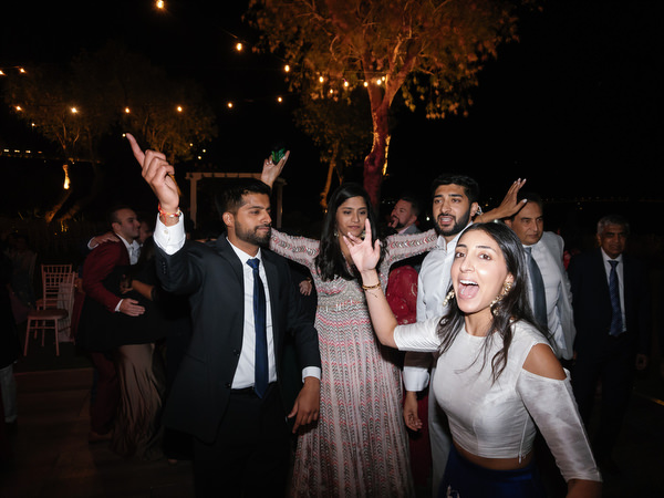 Guests dancing together beneath string lights at Island Resort the Residence Athens Riviera