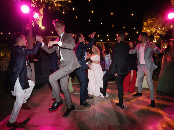 Guests cheering under pink lighting at Island Resort the Residence