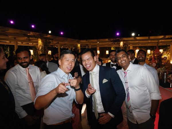 Friends posing and cheering at Island Resort the Residence during Indian wedding in Athens