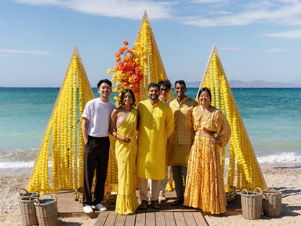 Wedding guests posing with Haldi ceremony decor
