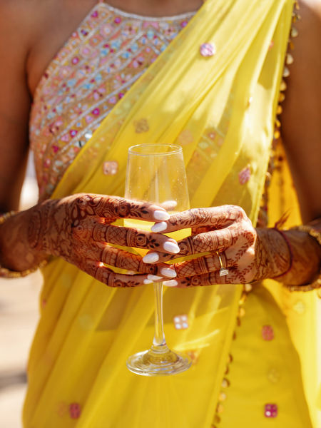 Bride hands holding coctail glass