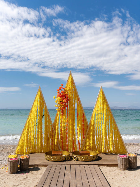 Yellow Haldi decor setup on the beach at the Athenian Riviera