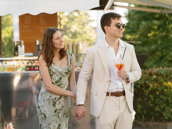 Guests raising glasses during Tuscany wedding welcome dinner