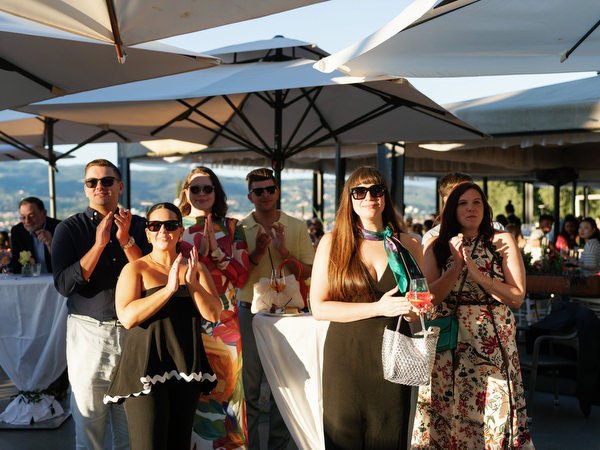 Guests applauding during emotional speech at Tuscany wedding dinner