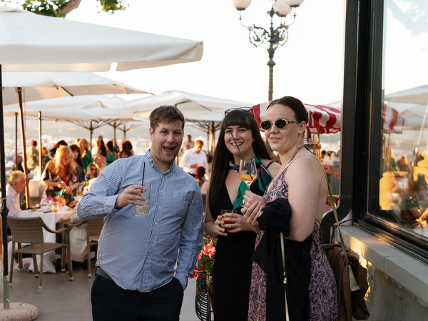 Guests raising glasses during Tuscany wedding welcome dinner