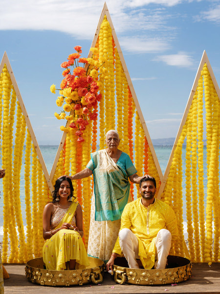 Family members applying turmeric to bride