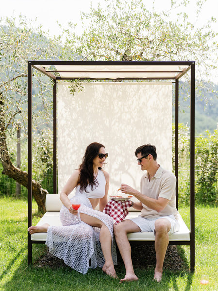 Bride and groom relaxing under pergola at Borgo I Vicelli