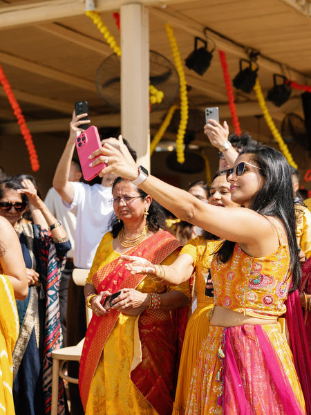 Guests cheering during Haldi ceremony celebration