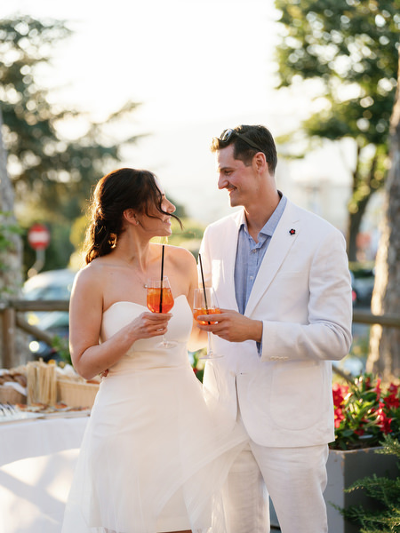 Couple laughing with friends during Tuscany wedding celebration