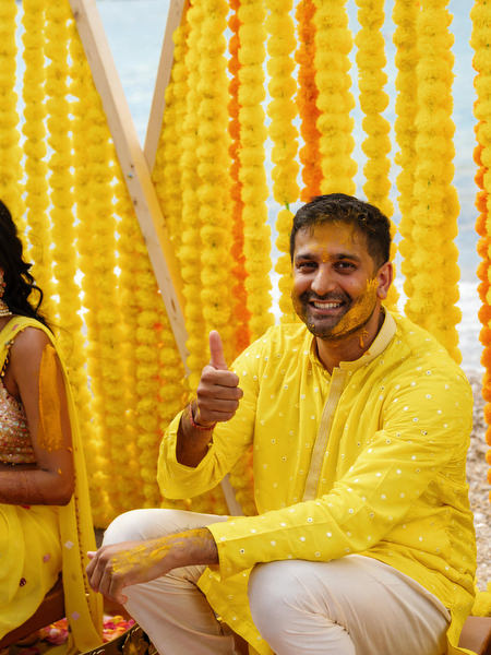 Groom laughing during Haldi ceremony ritual