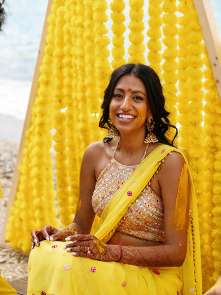 Bride portrait with yellow Haldi backdrop