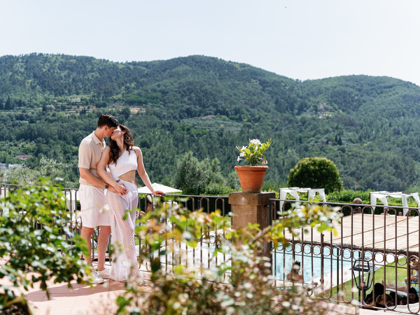 Newlyweds embracing during Tuscany wedding weekend pool party