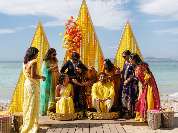 Haldi ceremony celebration with guests around couple