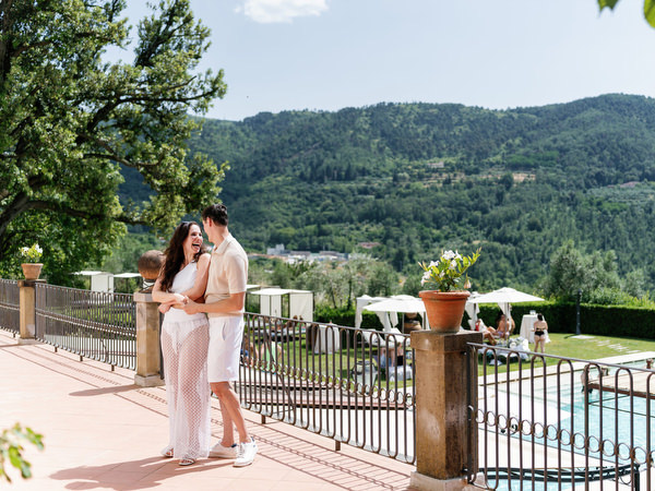 Couple embracing on terrace overlooking Tuscany