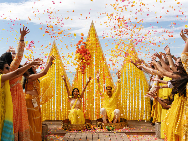 Guests throwing flower petals during Haldi ceremony