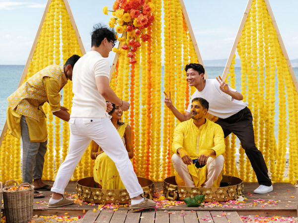 Family helping groom during Haldi ceremony ritual