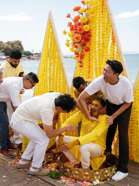 Family helping groom during Haldi ceremony ritual
