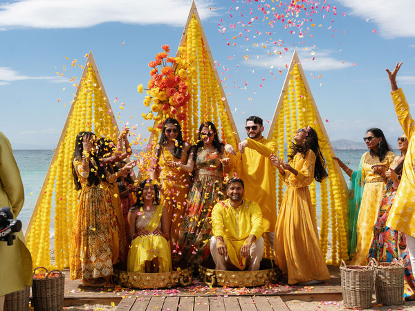 Group portrait during Haldi ceremony at Rubirosa throwing flowers