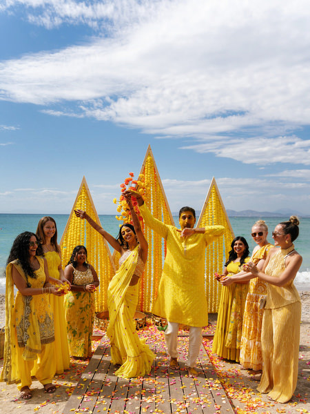 Groom and bride dancing during Haldi celebration