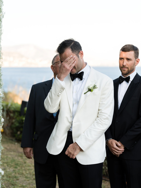 Emotional groom at Athens Riviera wedding ceremony.