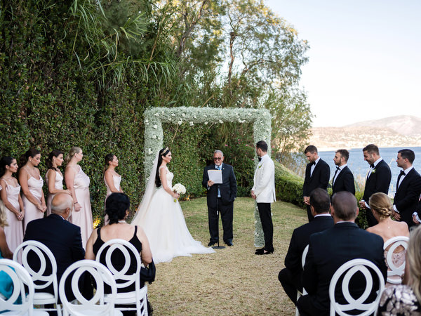 Floral ceremony arch at Island Resort Athens Riviera wedding.