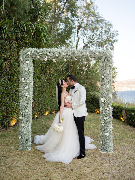 Private House Island Resort Athens Riviera Athens wedding portrait under floral arch.