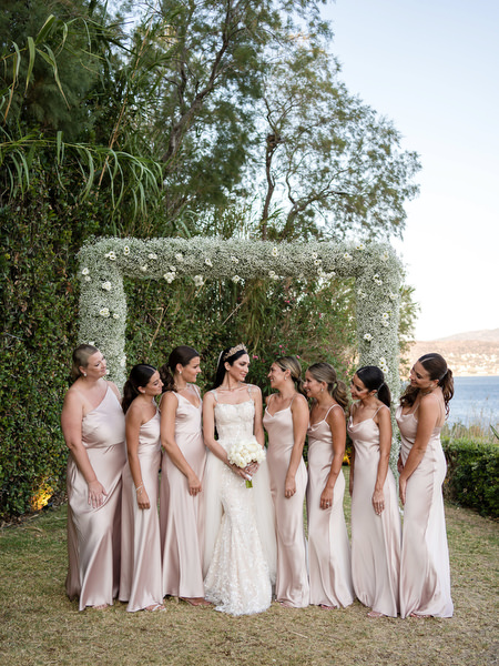Bride with bridesmaids at black and white Athens wedding.
