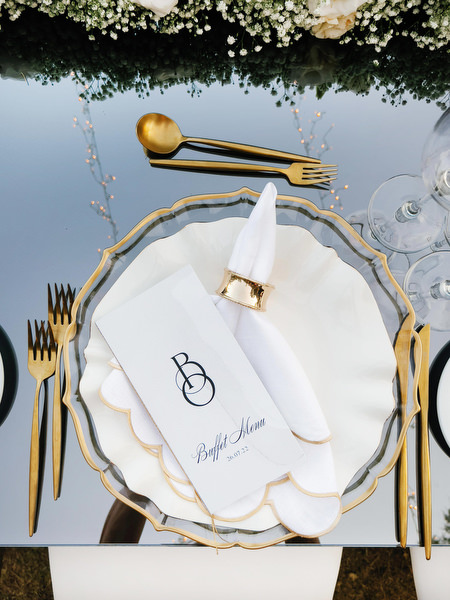 Luxury wedding place setting black and gold.