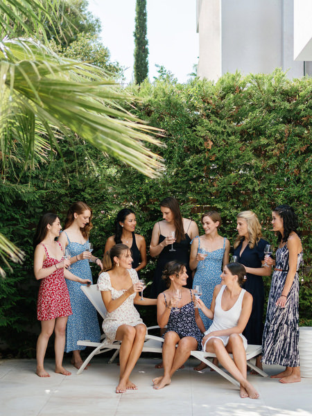 Bride with bridesmaids in garden setting at Island Resort, stylish Athens Riviera destination wedding in Greece.