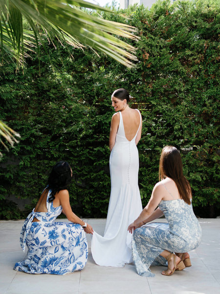 Bridesmaids adjusting the bride’s train at Island Resort, luxury Athens Riviera wedding venue.