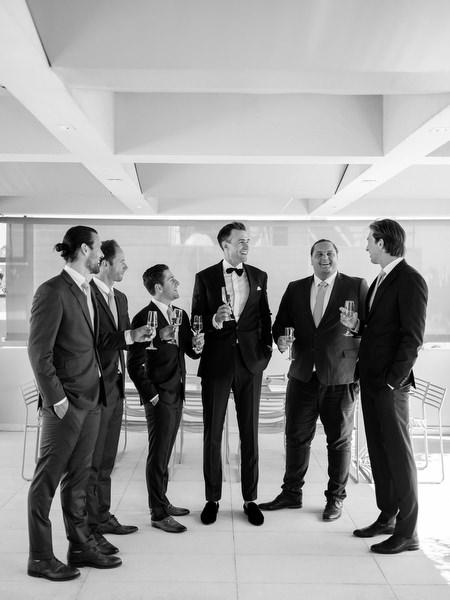 Groom and groomsmen celebrating at Island Resort before an Athens Riviera wedding celebration.