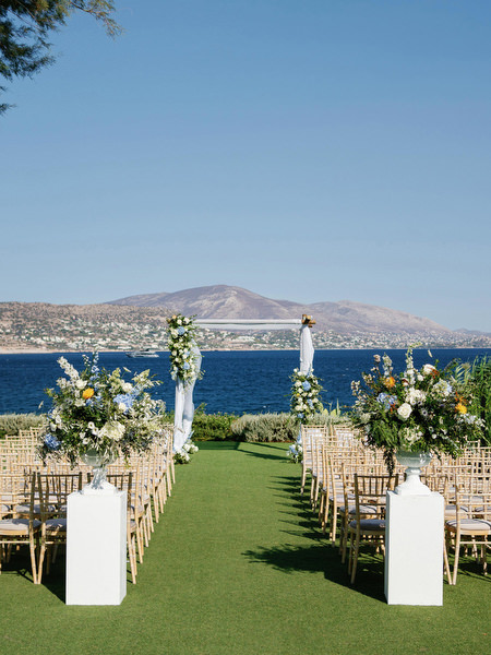 Wedding ceremony setup with ocean view at Island Resort, luxury Athens Riviera destination wedding in Greece.