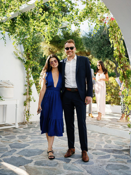 Wedding guests under Mediterranean archways at Island Resort, chic Athens wedding celebration in Greece.