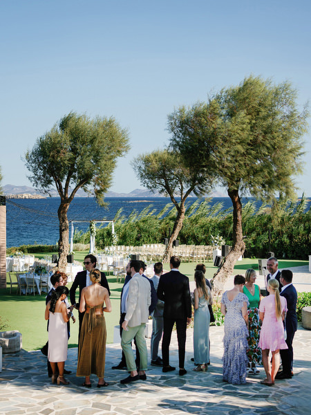 Guests gathering before the seaside ceremony at Island Resort, Athens Riviera wedding venue in Greece.