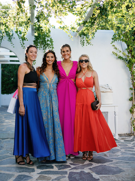 Stylish wedding guests posing at Island Resort, elegant Athens Riviera destination wedding in Greece.