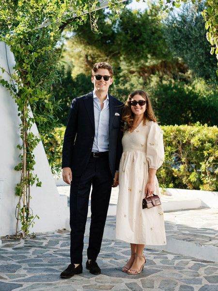 Guests posing under Mediterranean archways at Island Resort, chic Athens Riviera wedding celebration.